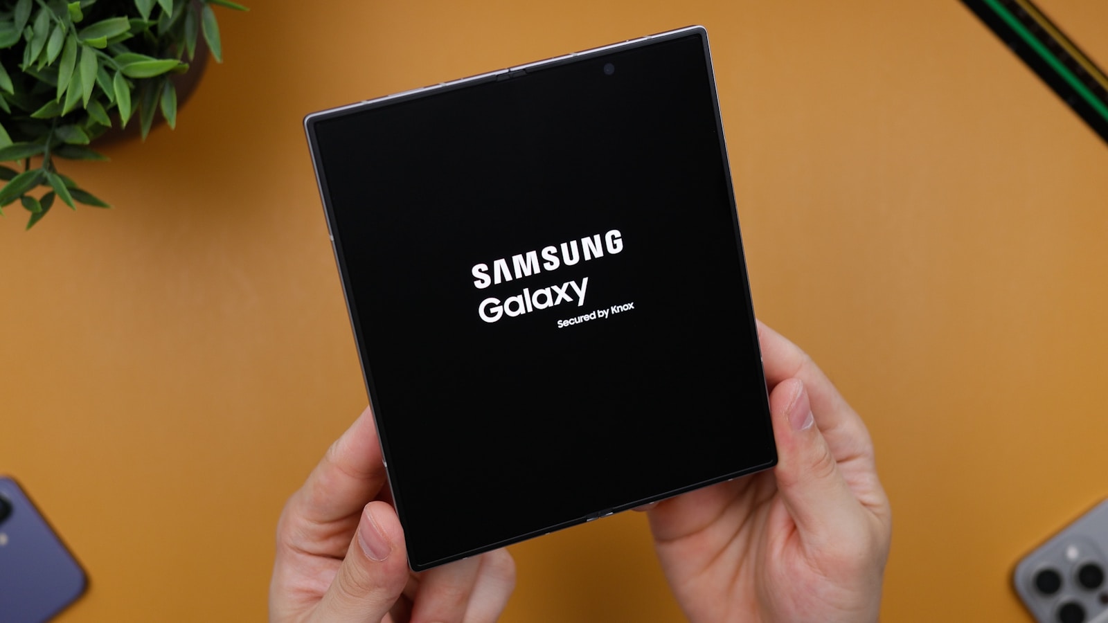 A person holding a black box with the samsung logo on it