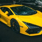 A bright yellow sports car parked outdoors.