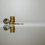 a stack of coins sitting on top of a reflective surface
